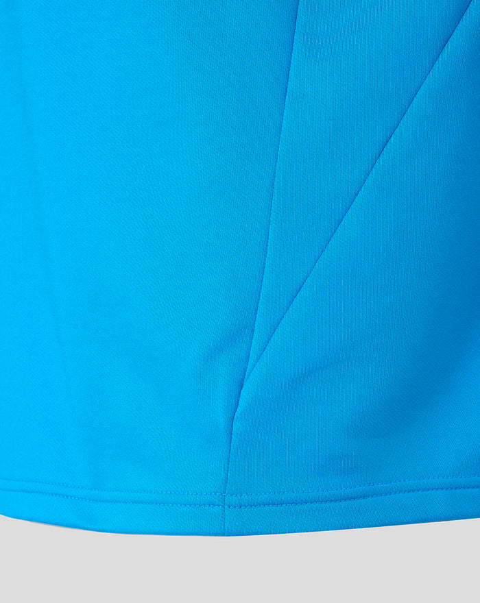 Lower front view of the blue FC Twente midlayer top showing panel stitching and hem detail