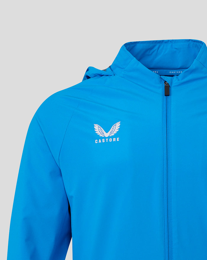 Close up of bright blue jacket chest featuring the Castore logo and a front zipper