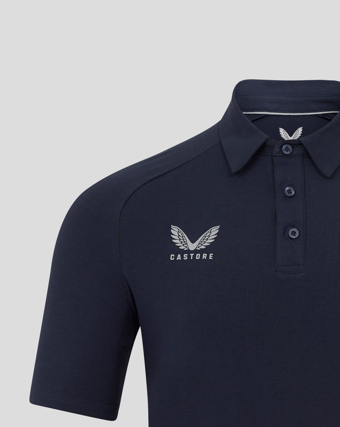 Front view of navy polo featuring a large winged emblem and Castore branding on the chest
