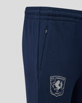 Close-up of navy Travel Knit pants showing a zip pocket and the club crest on the leg