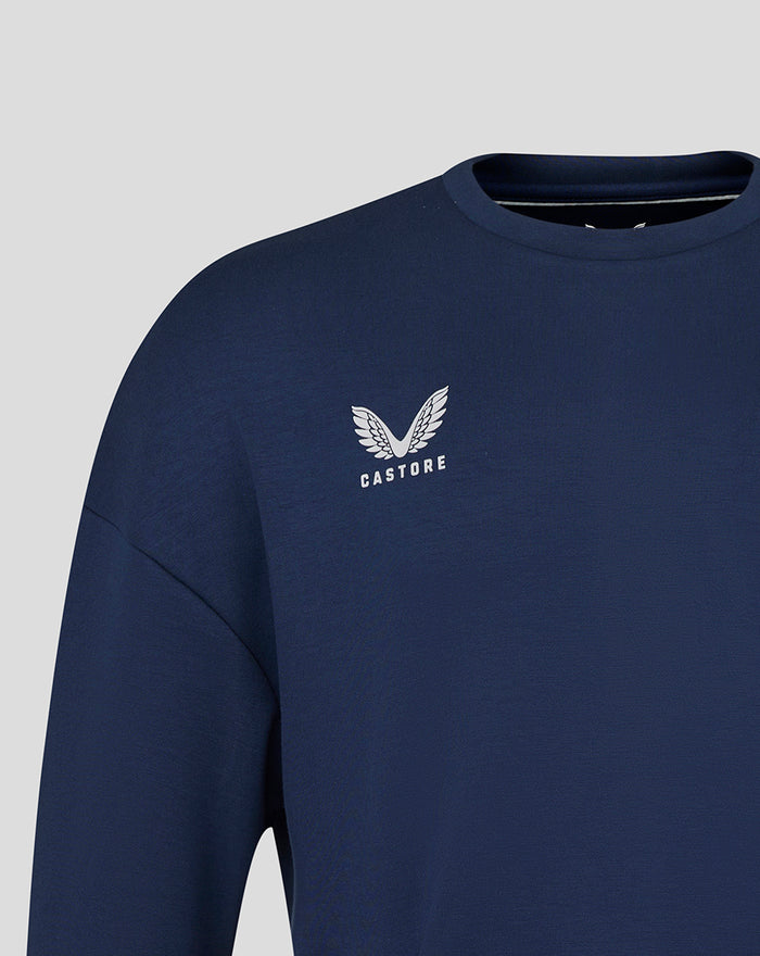 Close-up of a navy FC Twente travel crewneck sweater with a white Castore logo on the chest.
