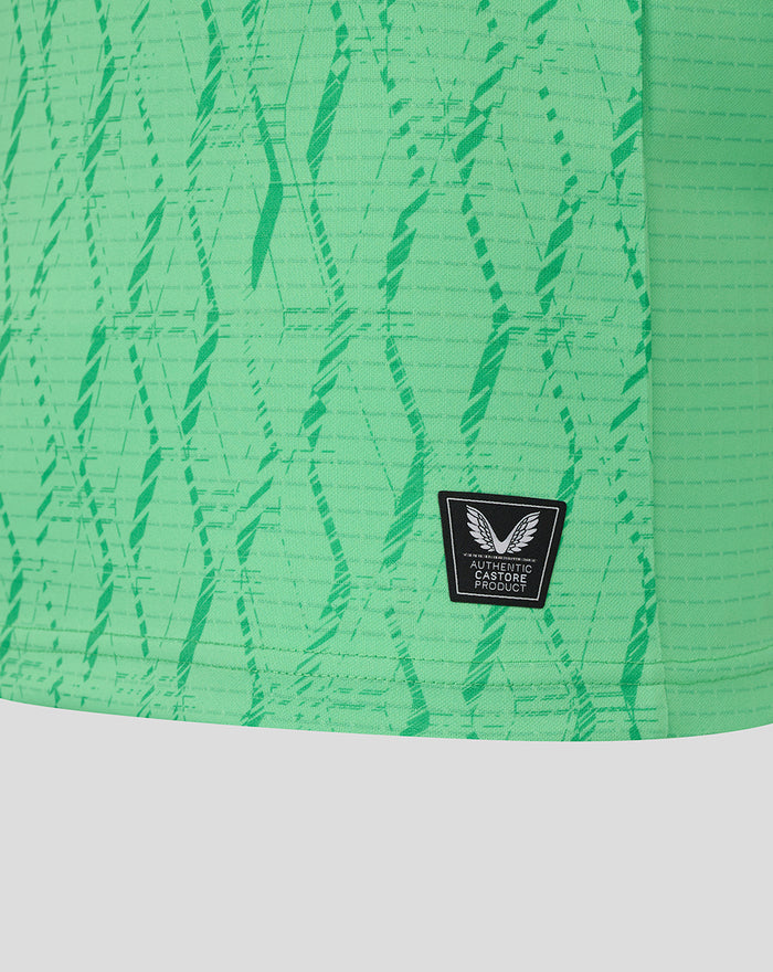 Closeup of light green FC Twente keeper shirt fabric with abstract print and Castore authenticity patch