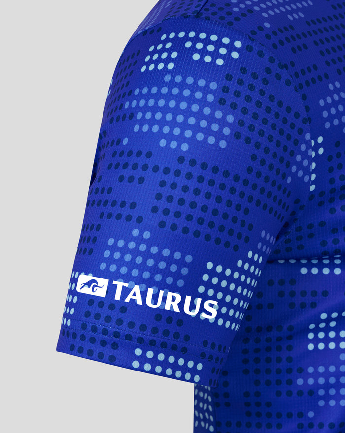 Detailed view of the blue shirt fabric with a dotted print and the Authentic Castore Product badge on the chest