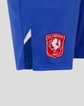 Red FC Twente crest patch sewn on blue shorts fabric