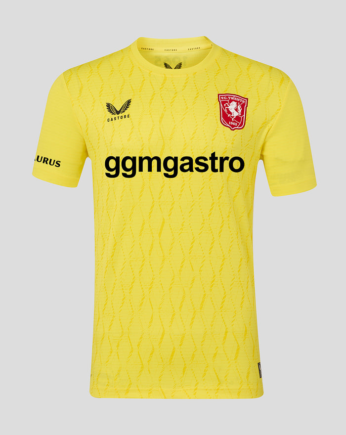 Front view of yellow FC Twente keeper shirt with crest on chest and bold sponsor text across the front