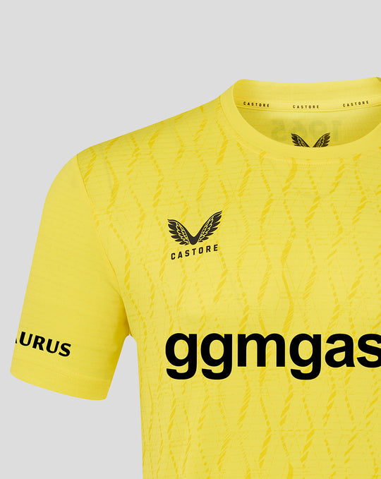 Upper section of yellow FC Twente keeper shirt showing crest, diagonal textured pattern and collar detail.