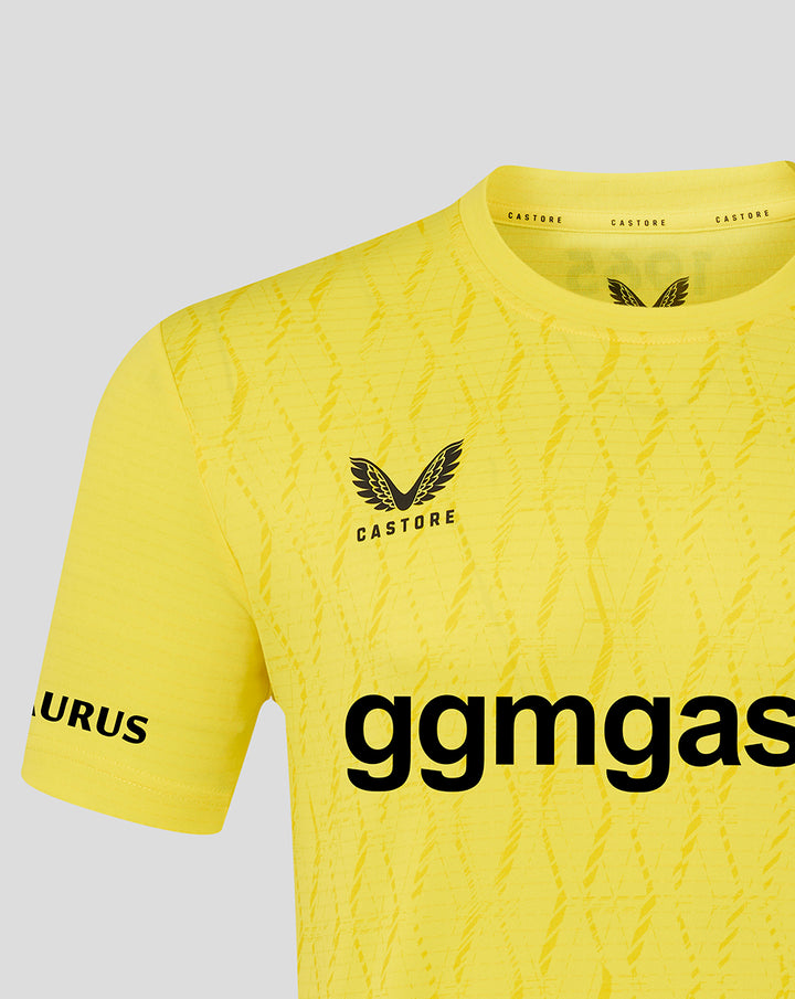 Upper section of yellow FC Twente keeper shirt showing crest, diagonal textured pattern and collar detail.