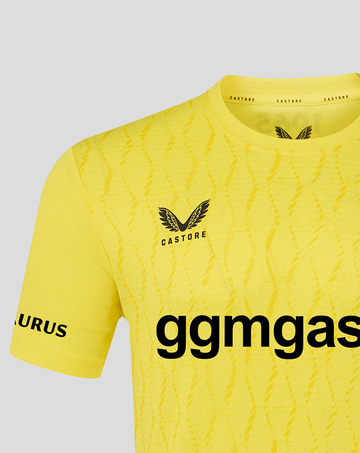 Upper section of yellow FC Twente keeper shirt showing crest, diagonal textured pattern and collar detail.
