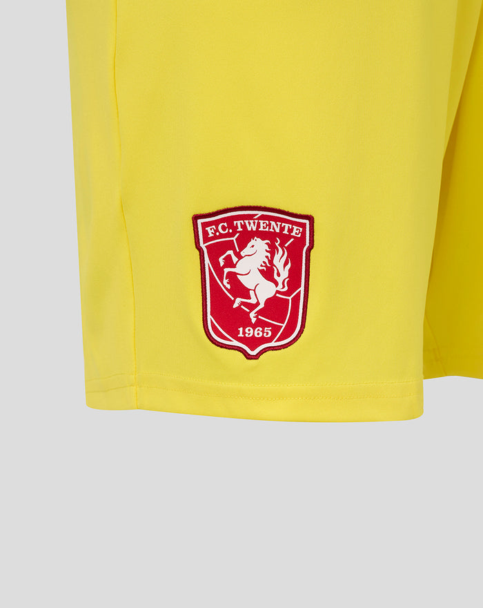 Close-up of yellow FC Twente keeper shorts showing crest on left leg.