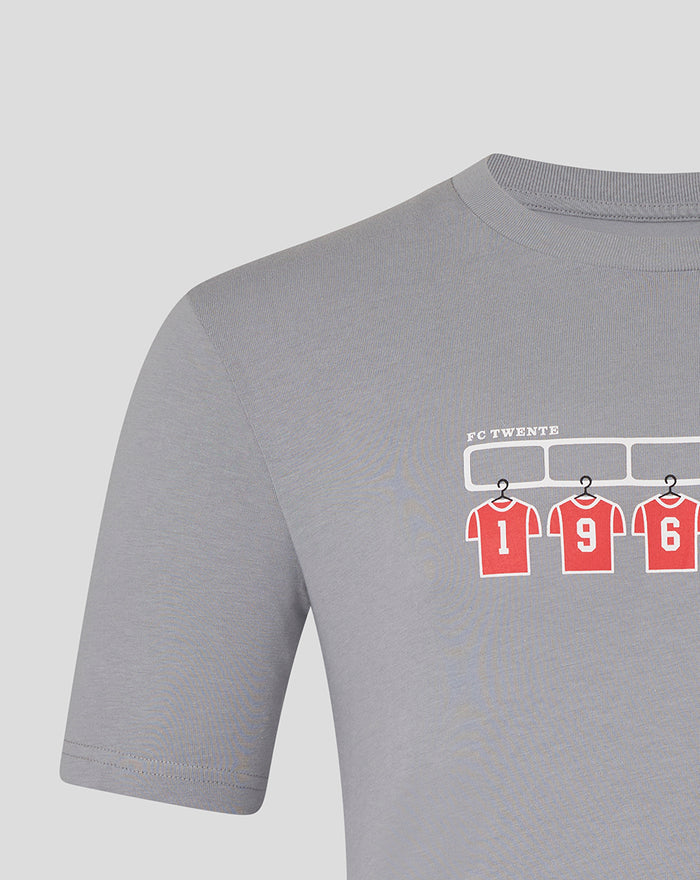 Light gray FC Twente T shirt with a wardrobe graphic of red numbered jerseys hanging under a rack and FC TWENTE text