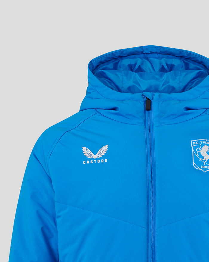 Front close-up of bright blue FC Twente jacket with crest on the left chest, Castore logo on the right, and central zipper.