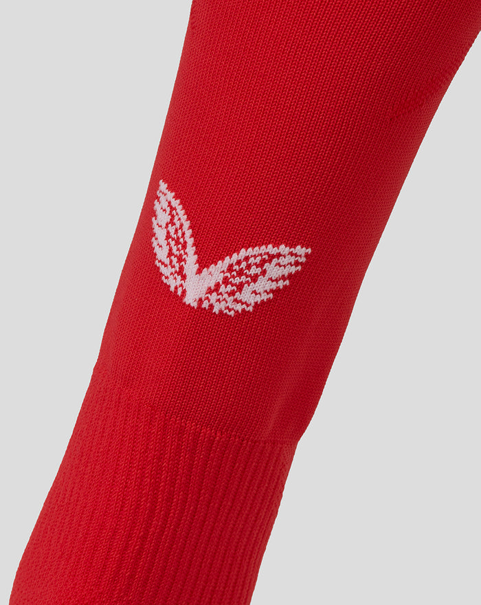 Red FC Twente home sock close up with white Castore wings emblem on the shin.