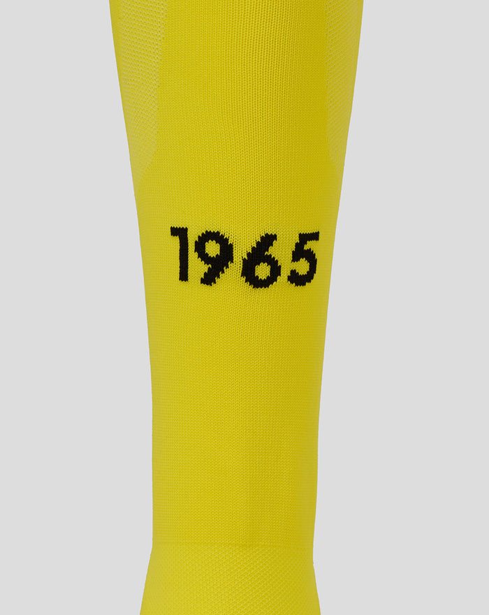Close up of yellow FC Twente keeper sock fabric showing the 1965 year detail on the calf.