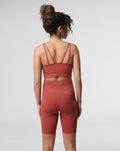 Back view of a model wearing a rosewood Active Core Sports Bra with double back straps.