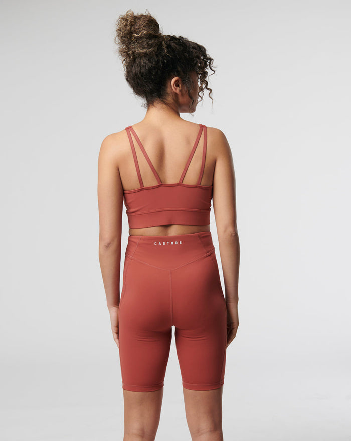 Back view of a model wearing a rosewood Active Core Sports Bra with double back straps.