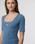 Blue active contour crop top with square neckline and white Castore logo on the chest
