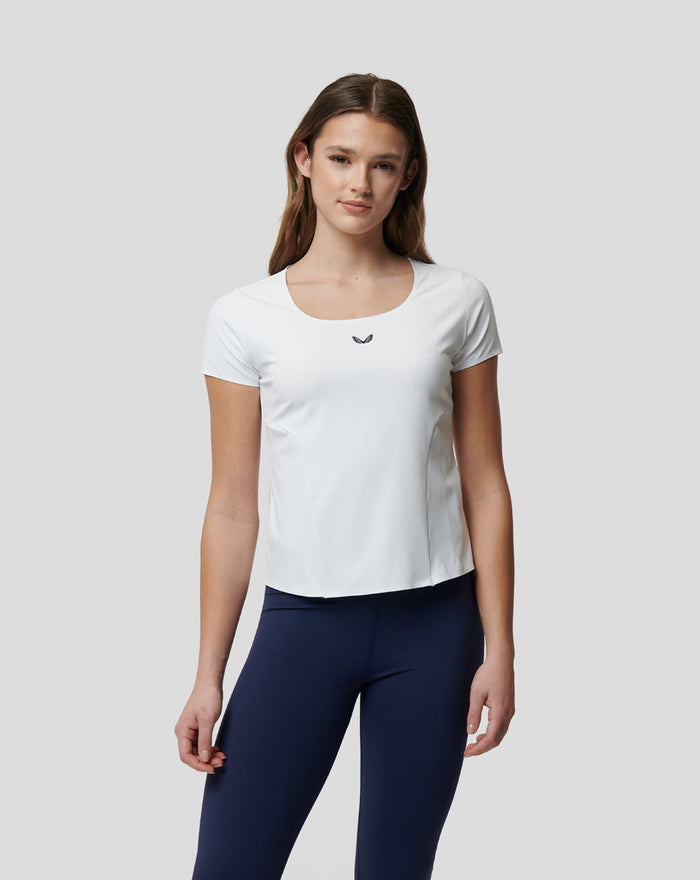 Woman in white Active Contour tee with square neckline and contoured seams