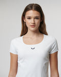 Front view of a woman in a white Active Contour Tee with a small chest logo.