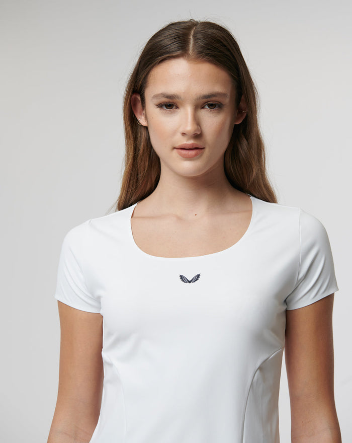 Front view of a woman in a white Active Contour Tee with a small chest logo.
