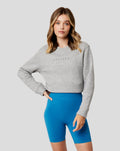 Front view of grey marl Apex Relaxed sweater with Castore logo on chest and cropped hem