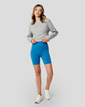 Three quarter front view of grey marl Apex Relaxed sweater on model with logo visible on chest