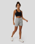 Full body shot of a model in black sports bra and grey Marl Apex shorts with a drawstring