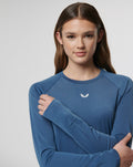 Woman wearing blue Carolina Vent Long Sleeve Tee with a small white chest logo