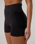 Close up of black Onyx BNS training shorts showing side panel and curved seam at the hip.