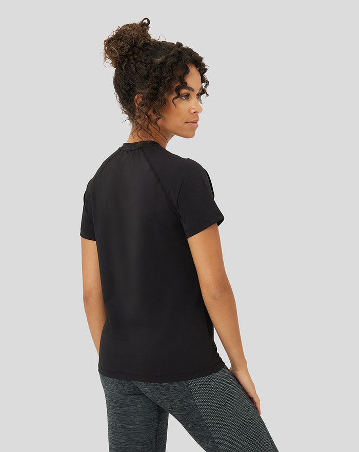 Back view of a woman in a black Protek training T shirt