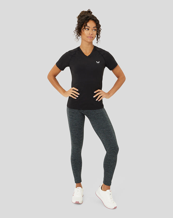 Model wearing black V neck Protek training T shirt with small chest logo, paired with dark heather leggings.