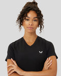Model wearing black Protek V neck tee with small white chest logo.