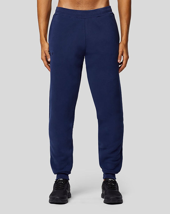 Navy Apex Sweatpants front view on model with relaxed fit and cuffed ankles