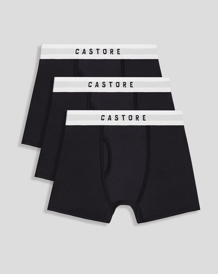 Three black Castore boxer shorts with white branded waistband arranged in a stacked display.
