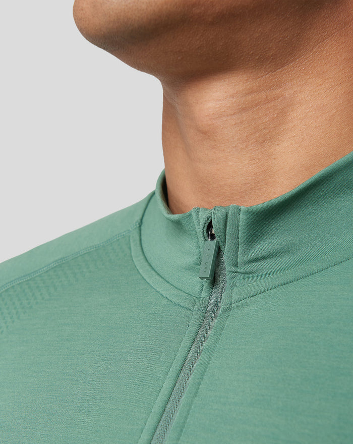 Close-up of the sage green seamless 1/4 zip neckline with zipper pull
