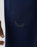 Close-up of navy Pace Trousers fabric with a wing logo