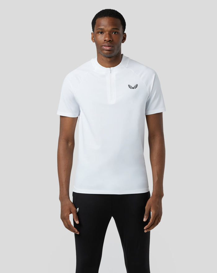 Front view of a model wearing a white BNS 1/4 Zip Top with concealed zip and chest logo.