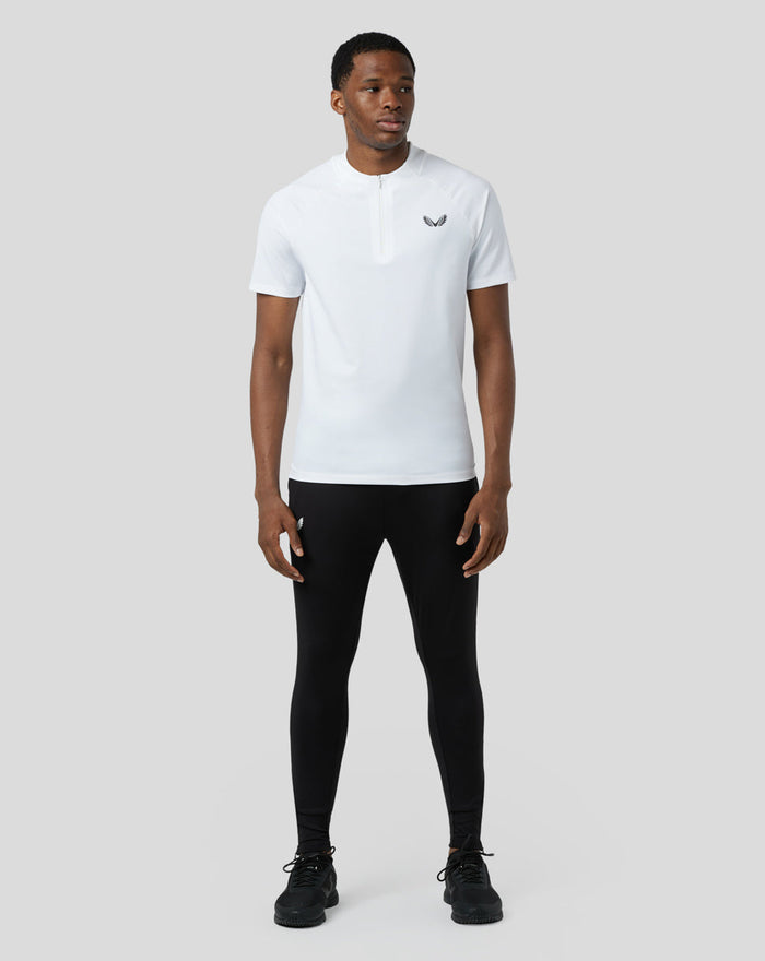 Male model in white lightweight training 1/4 zip top with concealed zip and chest logo.