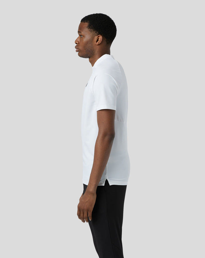 Side view of male model in white lightweight training 1/4 zip top with concealed zip.
