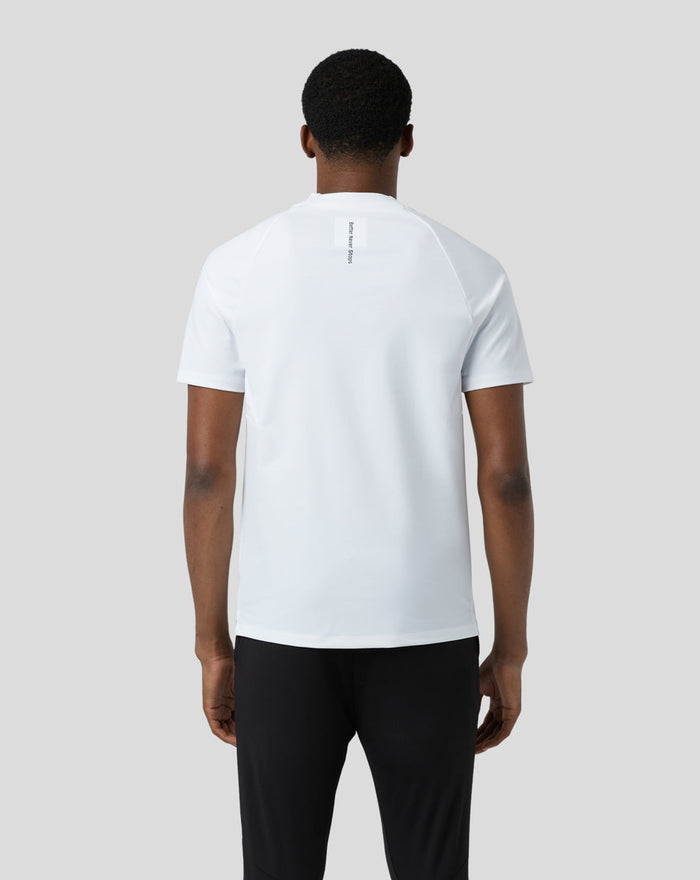 Back view of a model in a white BNS 1/4 Zip Top with neck label visible at the upper back.