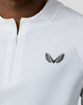 Close-up of the left chest logo on a white BNS 1/4 Zip Top with zipper detail.