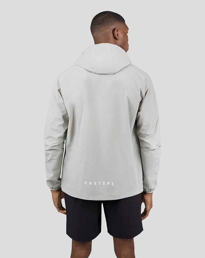 Back view of the light grey and turquoise Flyweight Jacket with CASTORE branding at the hem