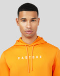 Close up of male model in bright orange Mandarin Scuba Hoody 3.0 with CASTORE across chest.