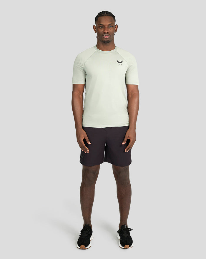 Male model wearing a light khaki short sleeve training T shirt with a slim athletic fit from the Ore Capsule collection
