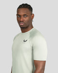 Side profile of a man wearing pale khaki short sleeve training T-shirt.