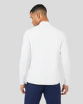 Back view of a model wearing a white Mist Metatek 1/4 Zip top with a clean silhouette