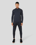 Full-body shot of a male model wearing Onyx Metatek 1/4 Zip with zipped side pockets and tonal branding