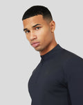 Close-up of a male wearing Onyx Metatek 1/4 Zip with high collar and chest branding