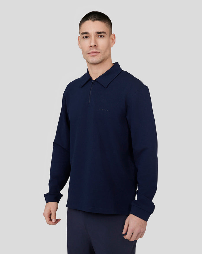 Male model wearing navy Midnight Metropolis Zip Polo with stand collar and subtle chest branding