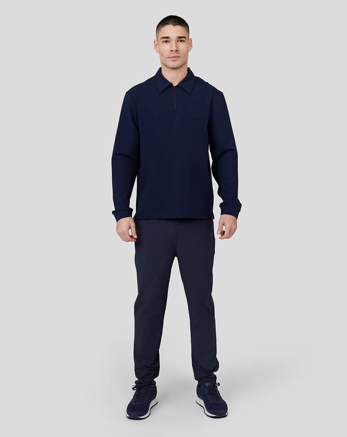 Male model facing camera in navy Midnight Metropolis Zip Polo with stand collar and quarter zip