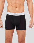 Close up of black Upgrade boxer shorts with a white waistband on a male model.